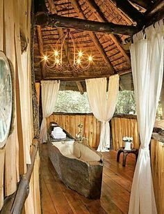 a bathroom with a tub and chandelier in it