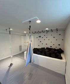 an empty room with black and white items hanging from hooks