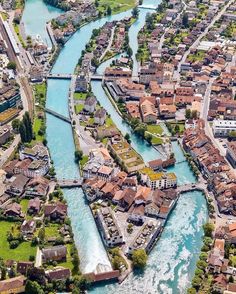 an aerial view of a river running through a city with lots of buildings on both sides