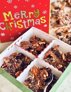 three christmas desserts are in a box on the table next to a merry card