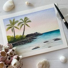 watercolor painting with shells and seashells on the table next to it is an image of two palm trees