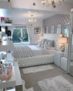 a bedroom with a bed, mirror and lights on the wall next to each other