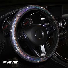 the steering wheel cover is decorated with multicolored sequins and sparkles