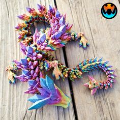 some very pretty colorful flowers on a wooden table