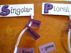 two pieces of paper that say singular and ploral on the same piece of string