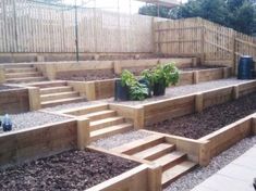 the steps are made out of wood and have plants growing on them in front of it