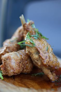 some food is sitting on top of a wooden plate