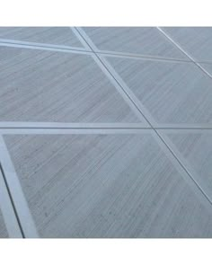 an aerial view of a white tiled floor with lines in the center and diagonals on each side