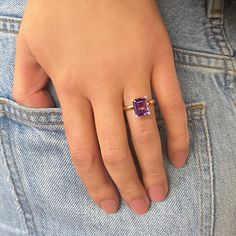 This stunning statement ring contains a 10x8mm emerald-cut amethyst in a beautiful purple hue. The amethyst is set in a four-prong setting with a unique twist - there are 4 small diamonds bezel-set at the top of each claw (approximately 0.04ctw). Crafted from vibrant 18K yellow gold, it is currently a finger size 6.5.Retail Replacement Value: $1,950 Pyrope Garnet, Alternative Wedding Bands, Gold Pearl Ring, Gold Topaz, Amethyst And Diamond Ring, Mabe Pearl, Heart And Key, Key To My Heart, Cluster Pendant