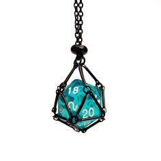 a blue and black dice is hanging from a chain