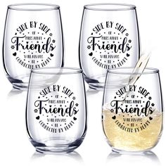 four wine glasses with sayings on them and one has a straw in the middle