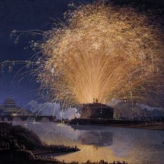 fireworks are lit up in the night sky over a body of water with buildings on either side