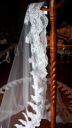 a wedding veil on a wooden chair in a room