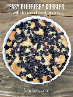 an easy blueberry cobbler with frozen blueberries in a pie pan on a wooden table