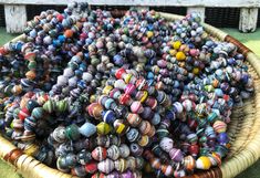 a basket filled with lots of different colored beads