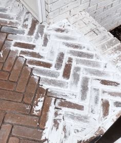 a brick walkway with snow on it