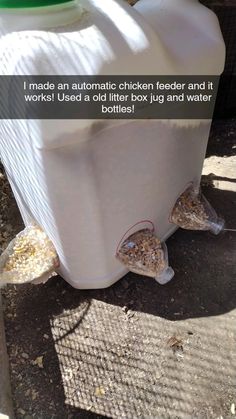 a plastic container filled with sand next to a fence