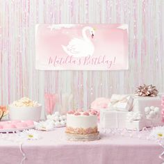 a pink swan themed birthday party with cake, candy and desserts on the table