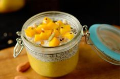 a glass jar filled with food sitting on top of a wooden cutting board