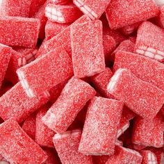 a pile of red sugar cubes sitting on top of a table