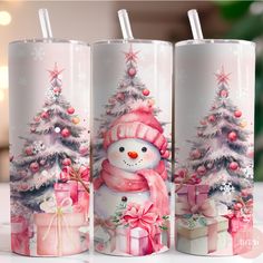 three coffee mugs decorated with christmas trees and presents