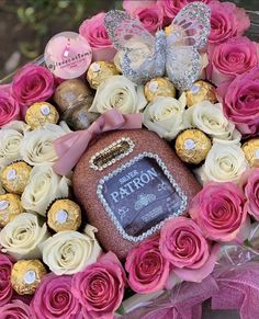 a bouquet of roses and chocolates with a plaque in the center that says happy birthday