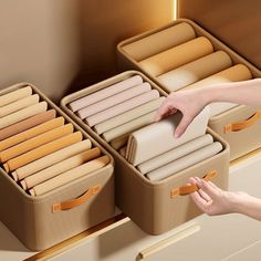 a woman is reaching for two suitcases on the shelf in front of her and another person's hand pointing at them