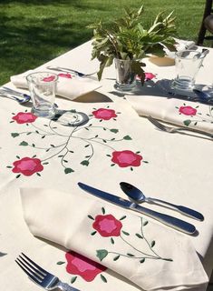 the table is set with flowers and silverware