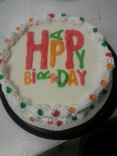 a birthday cake with the words happy birthday written in frosting and colored sprinkles