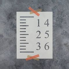 a piece of paper that has been taped to the side of a ruler with an arrow on it