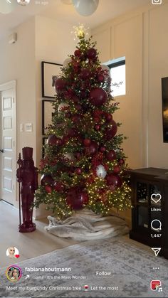 a christmas tree is decorated with red balls