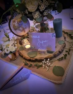 the table is set with candles, flowers and place cards for guests to write their names