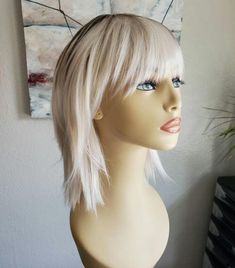 This wig is selected, cut, and styled by me personally. I create a look, photograph and describe.. from start to finish, this is my work. When you order one, I go to work! Each wig will have some small variations and its own personality. "What a fun wig! A cute cut and will be perfect for a costume I have for Burning Man!"                                     Llamamadre1  "Packaged carefully! This wig is gorgeously styled and meticulously put together so that that it comes perfect and ready to wear! I am in love with this company already!"                                     Paris H.  "Seller was extremely helpful and friendly, answering all of my questions. Shipped very quickly and the wig is even more beautiful in person then I imagined! I will enjoy wearing it! :-)" Blonde Shag Bob With Bangs, Face Framing Layers With Bangs, Blonde Feathered Bangs, Lilac Shag Hair, Shag Bob, Blonde Wigs With Bangs Heat Resistant, Long Ice Blond Wigs With Bangs, Shaggy Bob, Face Framing Layers