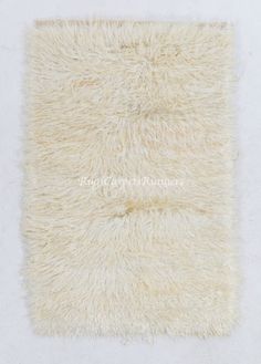 an area rug with white fur on it