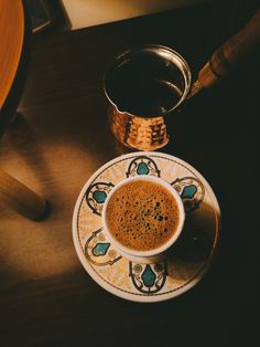 a cup of coffee sitting on top of a saucer