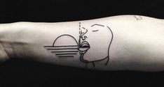 a person's arm with a tattoo on it that has an image of a woman blowing bubbles