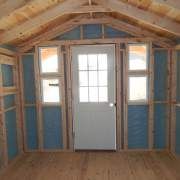 an unfinished room with blue walls and wooden floors