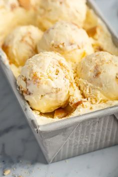 a tin filled with ice cream on top of a table