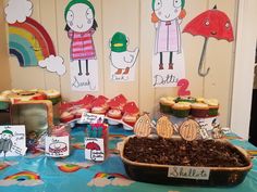 a table topped with lots of cupcakes covered in frosting and toppings