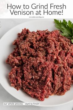 a white plate topped with meat next to parsley on top of a table and text overlay reads how to grind fresh venison at home