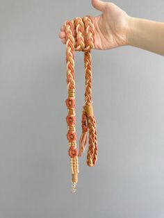 a hand is holding up some kind of rope