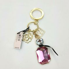 Brand New  Bombshell Keychain Charm Authentic original with tags Carry a little luxe. This Bombshell-inspired charm adds classic VS style to bags and keys. Attaches to totes, backpacks, or can be used separately as keychain 5” H Made from imported metal Brand lovers and bombshells alike will covet this pink and gold charm with a mini bag, Bombshell perfume bottle and V Monogram hardware. Condition is New with tags. 100 % Brand New All my items are Authentic Original directly from the Vendor or S Luxury Bag Charm With Keychain, Bag Charm With Keys As Gift, Logo Charm Keychains For Gifts, Gift Keychain With Logo Charm, Trendy Travel Bag Charm Keychain, Trendy Bag Charm As A Gift, Trendy Bag Charm Keychain Fashion Accessory, Gold Rectangular Keychain With Key Leash, Victoria Secret Jewelry