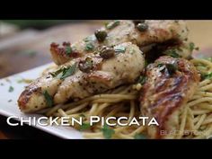 chicken piccata with pasta on a white plate