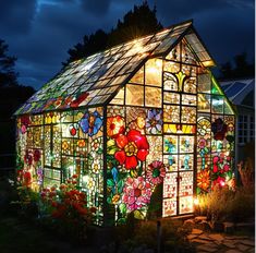 a house made out of stained glass is lit up at night