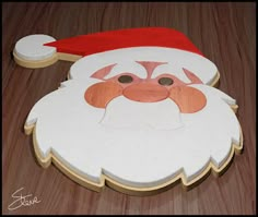 a cardboard santa claus face with a red hat