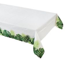 a white tablecloth with green palm leaves on it