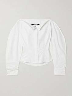 Unconventional shapes and unexpected details are quintessentially Jacquemus. This shirt is designed with a nipped-in waist balanced by exaggerated, geometric sleeves and turns to reveal a cutout back featuring an adjustable strap. It's made from crisp cotton-poplin has a boat neckline that's meant to be left unbuttoned at the top. Cotton Poplin Top, Geometric Sleeve, Sport Swimwear, Cotton Poplin Shirt, Sports Skirts, Knitwear Tops, Boat Neckline, Poplin Shirt, Jeans Dress