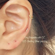 a close up of a person's ear with an ear piercing