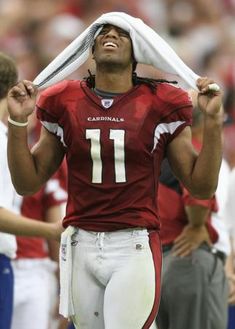 a football player is holding his head in the air