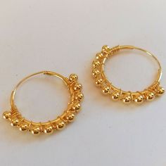 Pair of 2 cm diameter Hoop Earrings made in Sterling Silver with gold plating. These earrings are decorated with 3mm diameter beads set along the hoop. They are very elegant and original earrings that favor your face by providing light and harmony. They are made of 925 Sterling silver and have an 18 carat Gold plating that gives it a very elegant finish. The type of closure is Congo. The indicated price is for the PAIR of Earrings (right ear and left ear) Gold Hoop Beaded Earrings For Pierced Ears, Metal Hoop Beaded Earrings For Pierced Ears, Metal Hoop Beaded Earrings, Gold Wire Wrapped Hoop Earrings, Adjustable Hypoallergenic Hoop Wrap Earrings, Hypoallergenic Adjustable Hoop Earrings, Gold Hoop Beaded Earrings With Ear Wire, Gold Beaded Hoop Earrings With Ear Wire, Adjustable Hoop Earrings With Ear Wire